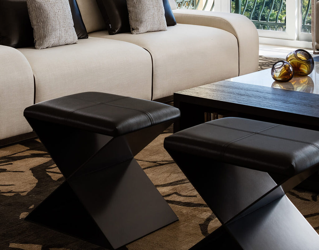 Mons Table with two black leather ottomans featuring metal resin coated X-shaped bases