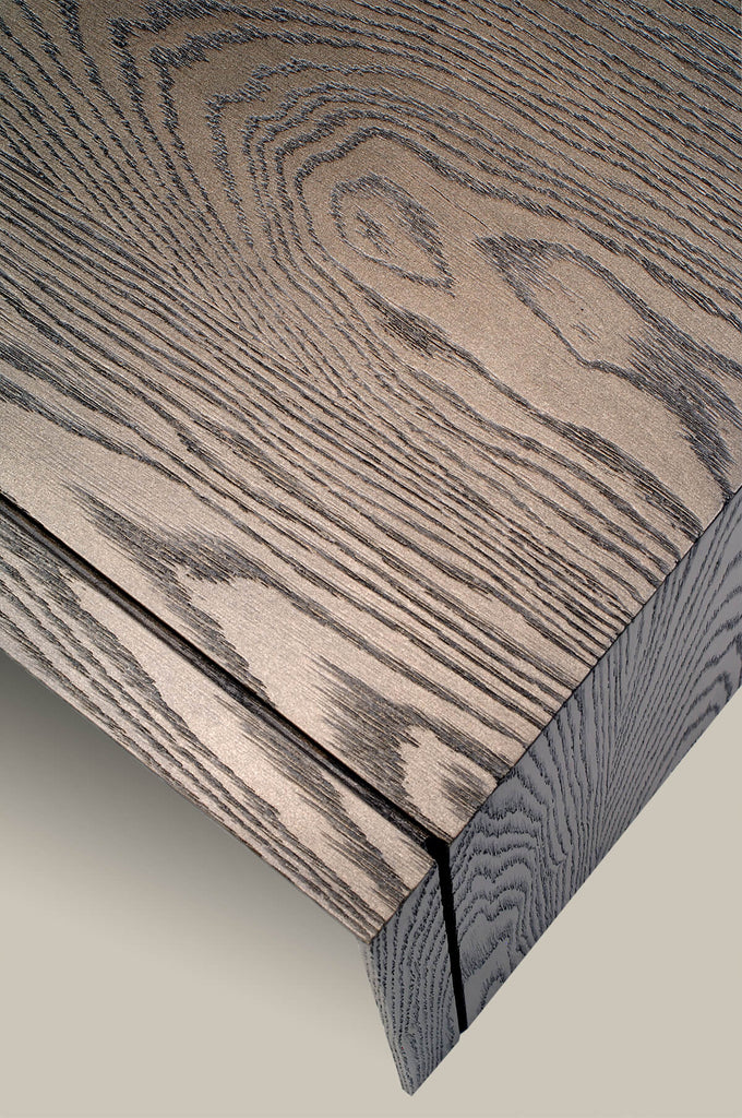 Close-up of light gray wooden surface with dark wood grain patterns on Vienna End Table