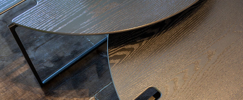 Moscow Table featuring a dark wood top with a sleek metal base for modern interiors