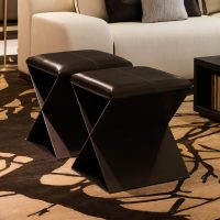 Santorini Stool with dark leather and wood X-shaped ottomans for stylish seating