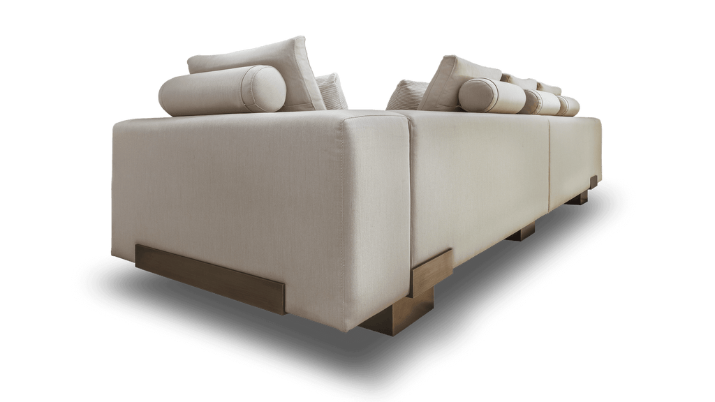 Amsterdam Sofa featuring a long light-colored modular design with bolster and square pillows