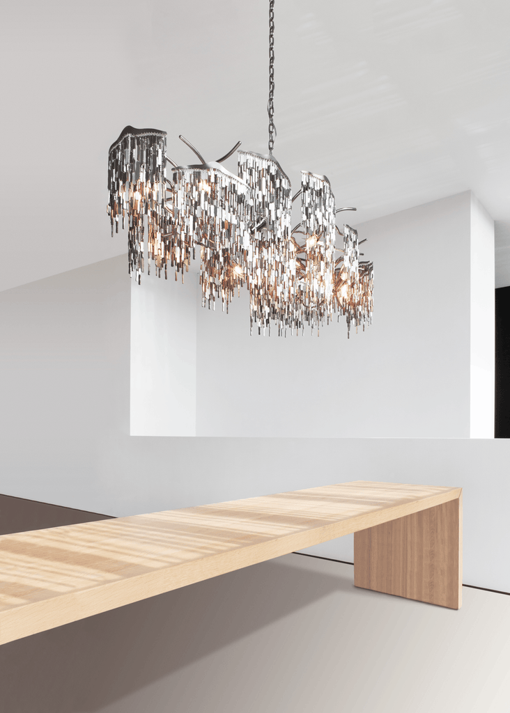Arthur Chandelier Oval featuring shimmering metal pieces and warm glow for elegant lighting