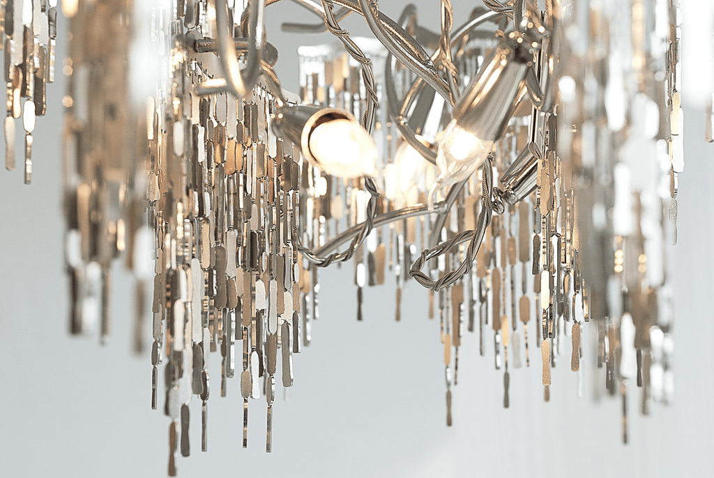 Arthur Chandelier Oval with modern design, multiple light bulbs, and cascading metallic accents