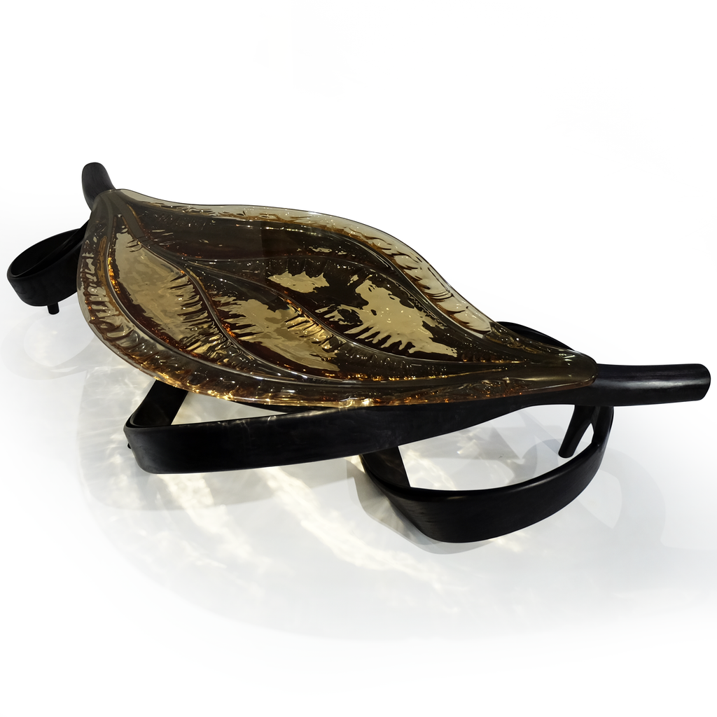 Decorative leaf-shaped glass bowl on Black Ivy Coffee Table with black metal stand