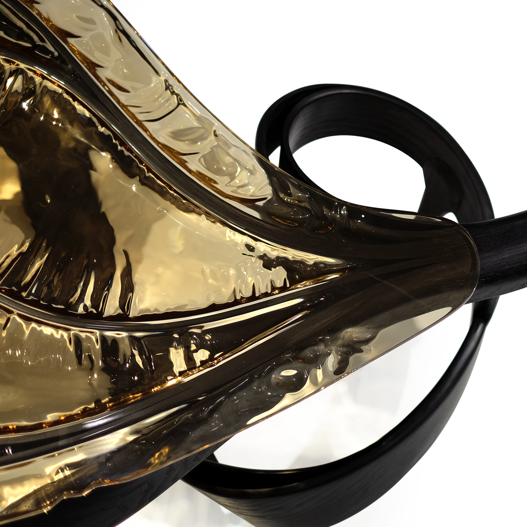 Decorative bronze-gold metal sculpture on Black Ivy Coffee Table with abstract design