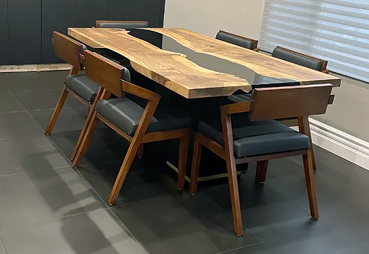 Black Thyria River Walnut Dining Table with grey resin river and dark leatherette chairs