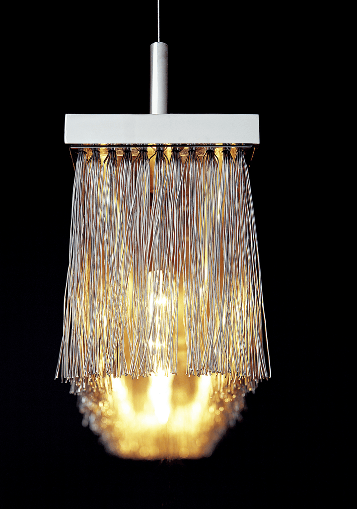 Broom Hanging Lamp with rectangular white top and metallic strand shade illuminating warm glow