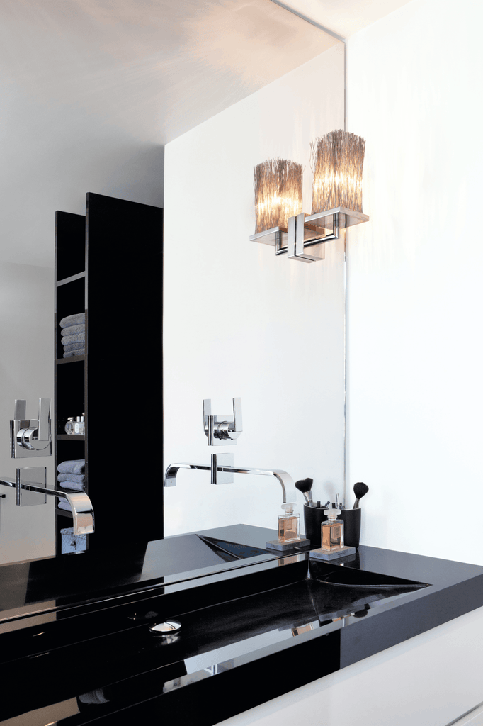 Modern bathroom vanity with black countertop, wall-mounted Broom Wall Lamp and sink
