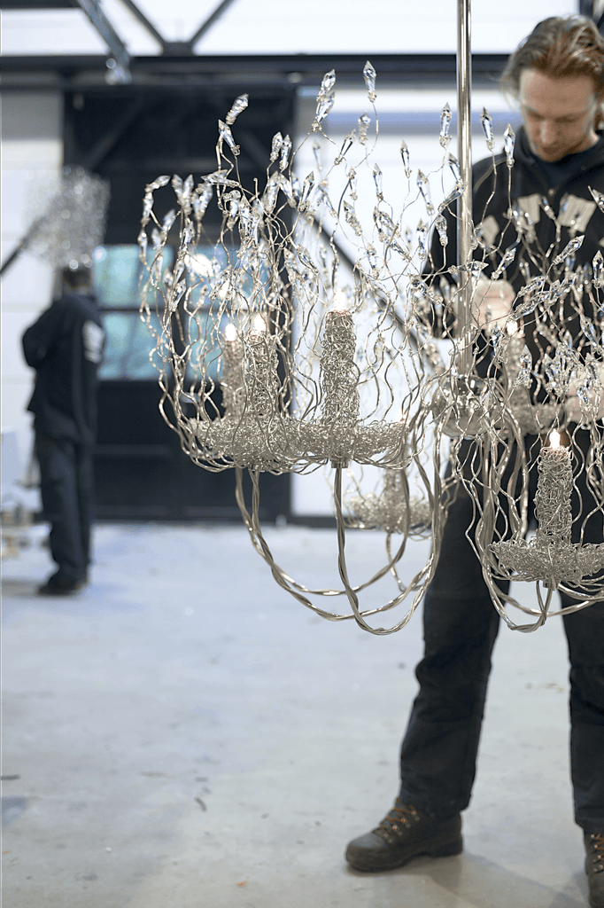 Ornate silver-colored wire spirits chandelier round with multiple candle-like light sources