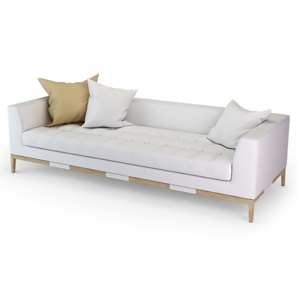 Costa Sofa featuring a long white tufted fabric design with light wooden frame and accent pillows