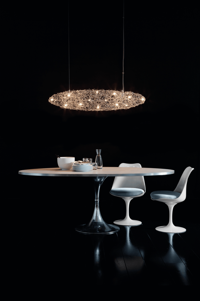 Modern dining set with Crystal Waters Hanging lamp, oval table, tulip chairs, ornate chandelier