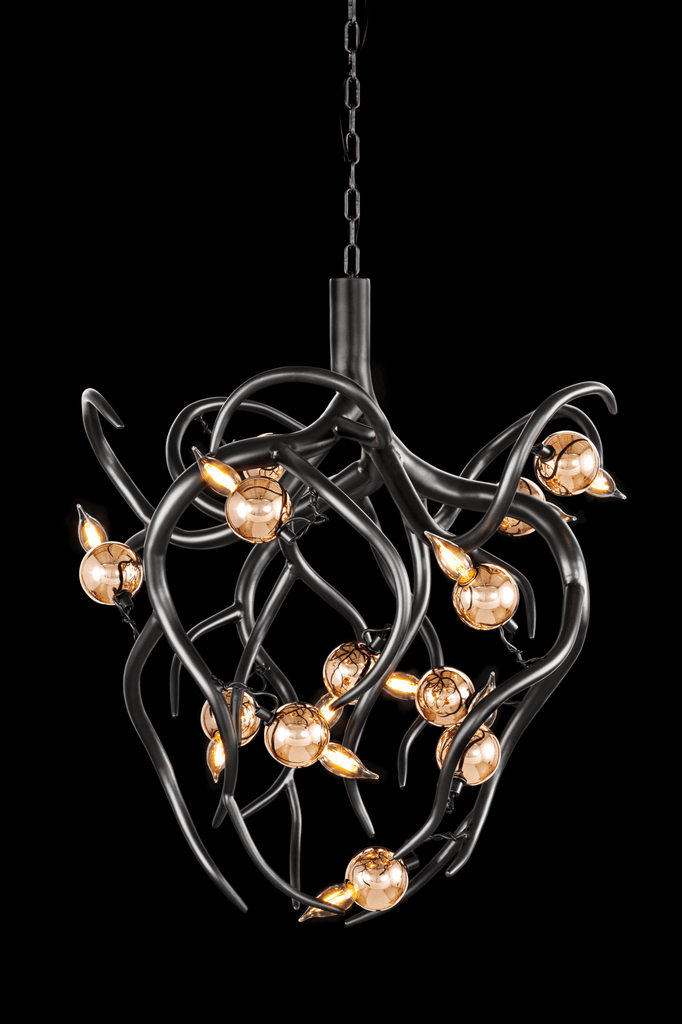 Eve Chandelier Conical with dark metal branches and amber glass globes lighting a room