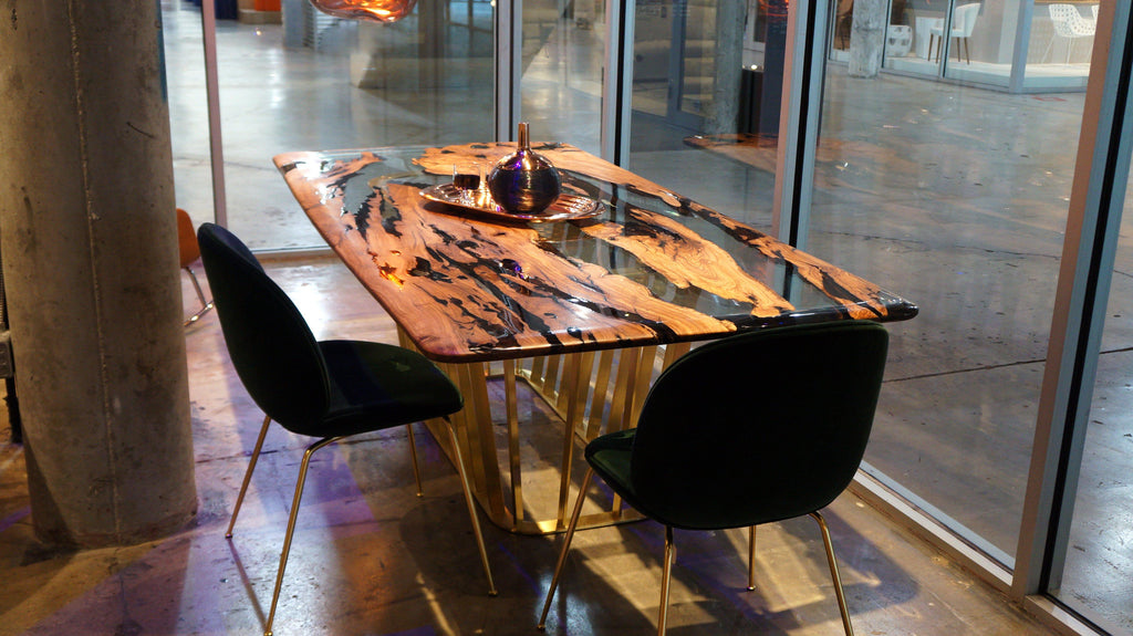 Giona Olive Dining Table with wood and black resin top and gold legs, olive dining style