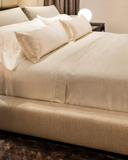 Hollywood Bed with neatly made bed featuring light-colored bedding for a stylish look