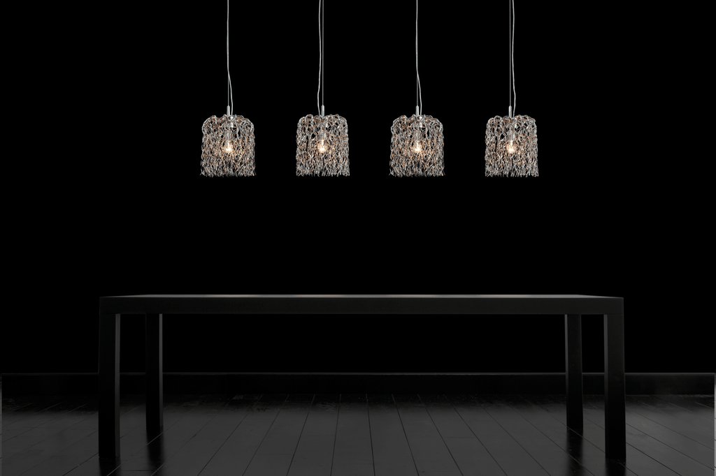Hollywood inline hanging lamp with textured cage pendant lights above a minimalist dining table