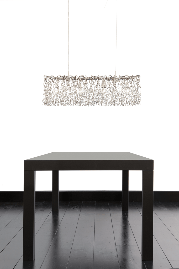 Hollywood Long Hanging lamp with modern wirework over dark dining table