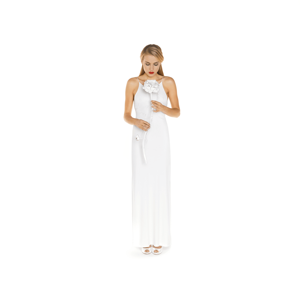 Solemn young woman in white maxi dress holding a white flower with La Vie En Rosa single decoration rose