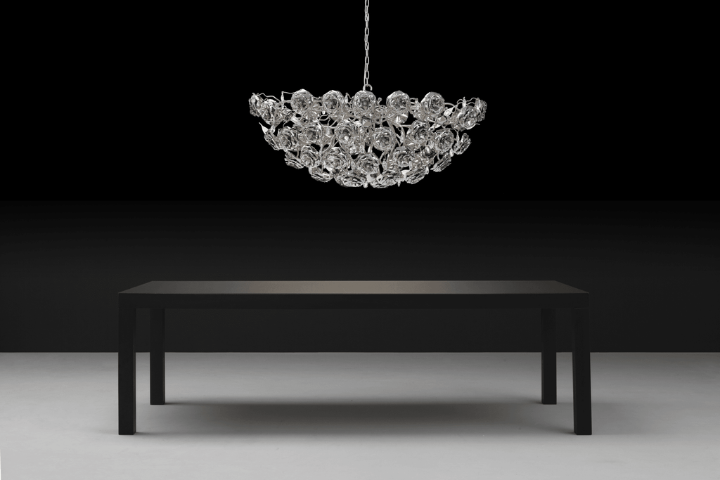 Dark rectangular dining table with a Love You Love You Not Chandelier Oval crystal chandelier overhead
