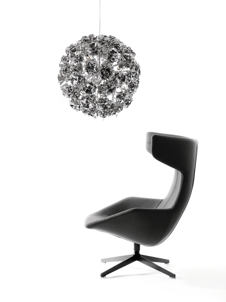 Modern dark grey lounge chair with high back and black swivel base next to Love You Love You Not Hanging Lamp