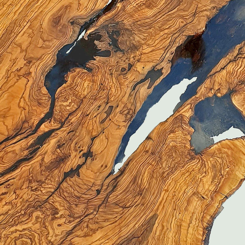 Olive Wood Round Dining Table with dark resin and white accents showcasing natural beauty