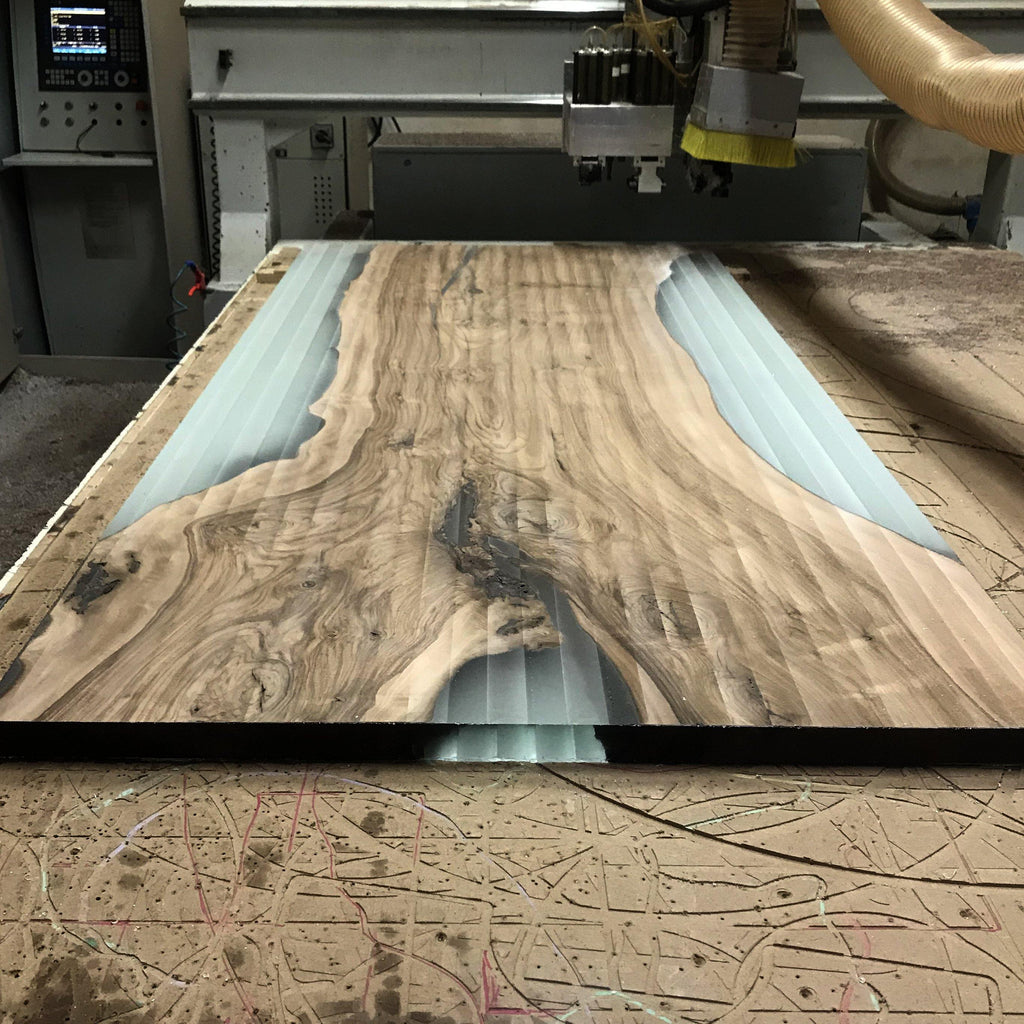 CNC carving of light blue resin inlay on Ombrone Walnut Dining Table walnut dining design