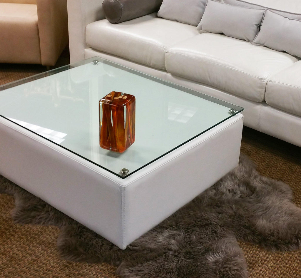 White upholstered coffee table with clear glass top in Orange Branches Cube style