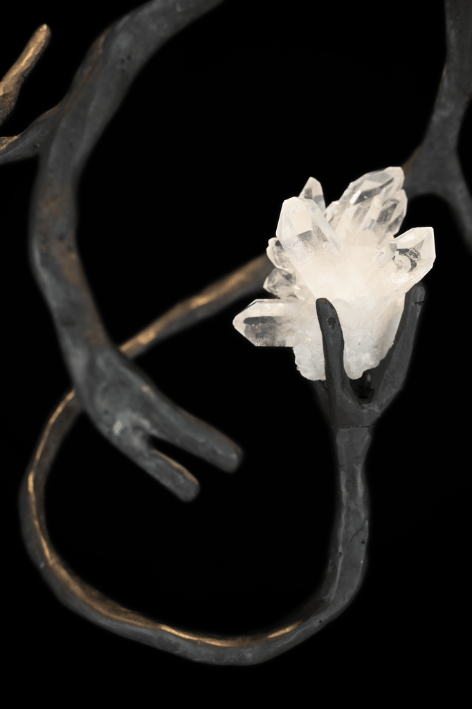 Bronze sculpture of hands holding a clear quartz mountain crystal for Orpheus Mountain Crystal Hanging Lamp