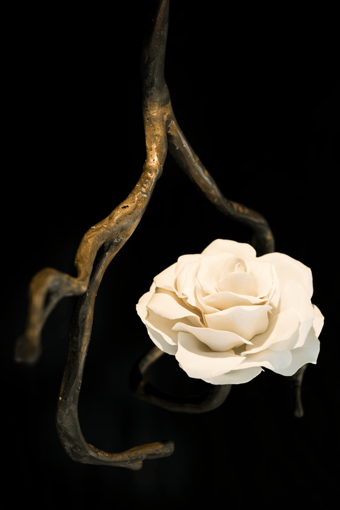 White artificial rose with dark gnarled branch on Orpheus Nymphenburg porcelain hanging lamp
