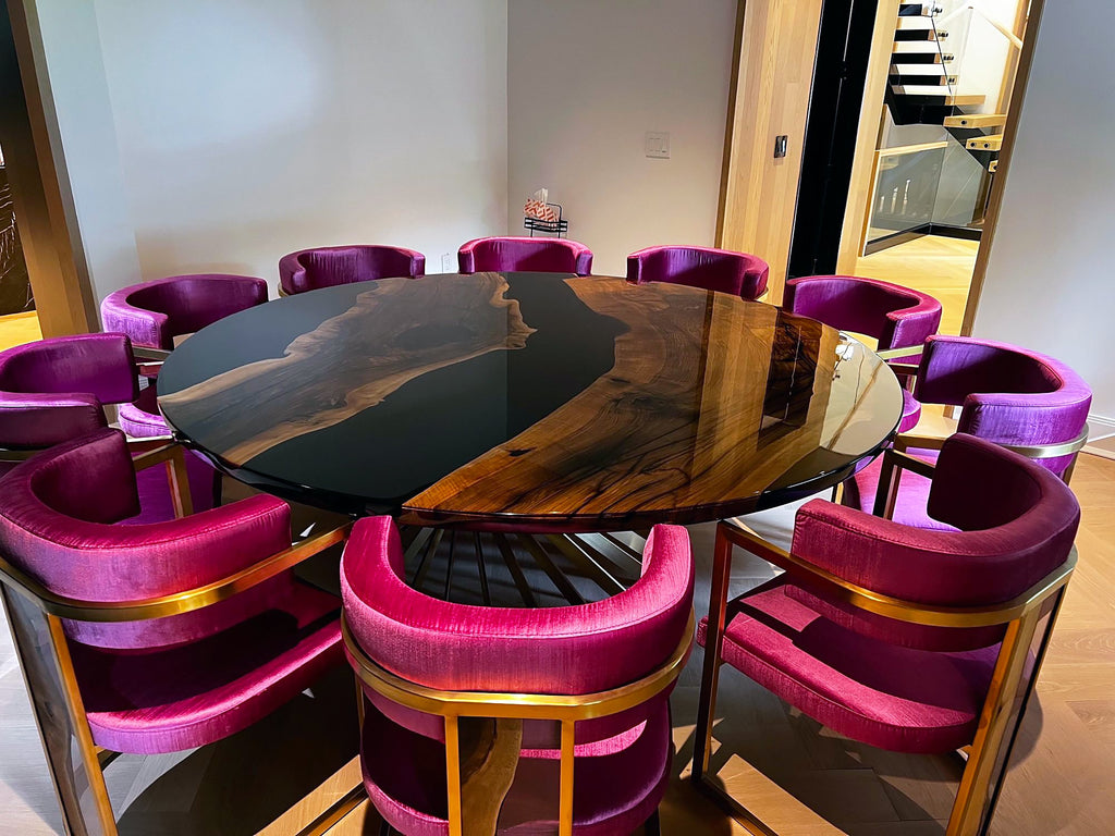 Panaro Walnut Wood Round Dining Table with black resin top and magenta velvet chairs