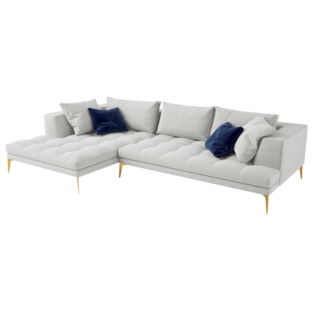 Light gray L-shaped Parma Sofa with gold tapered legs and dark blue throw pillows