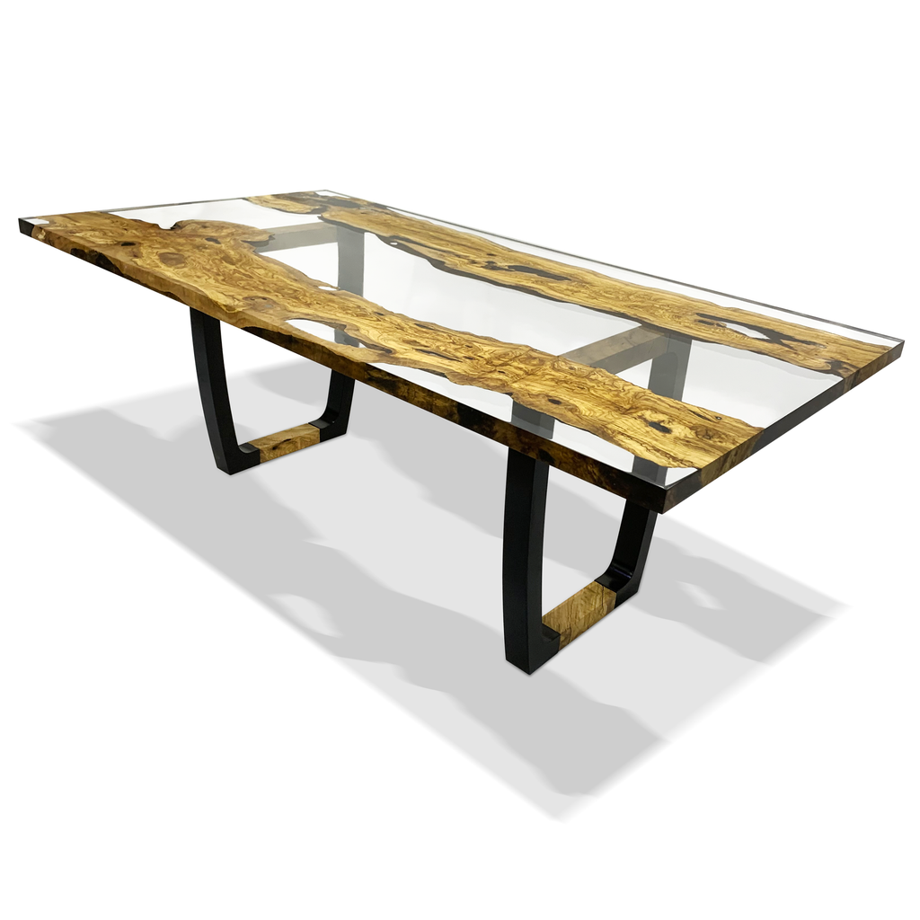 Staphyle Olive Wood Dining Table with clear resin top and black U-shaped metal legs