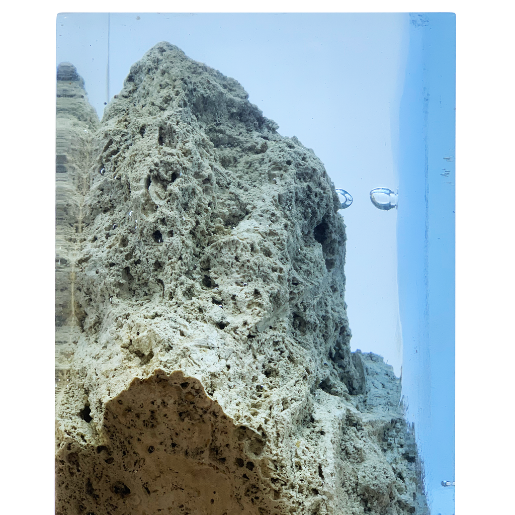 Textured travertine rock decorative cube with porous light grey and brown surface for aquariums
