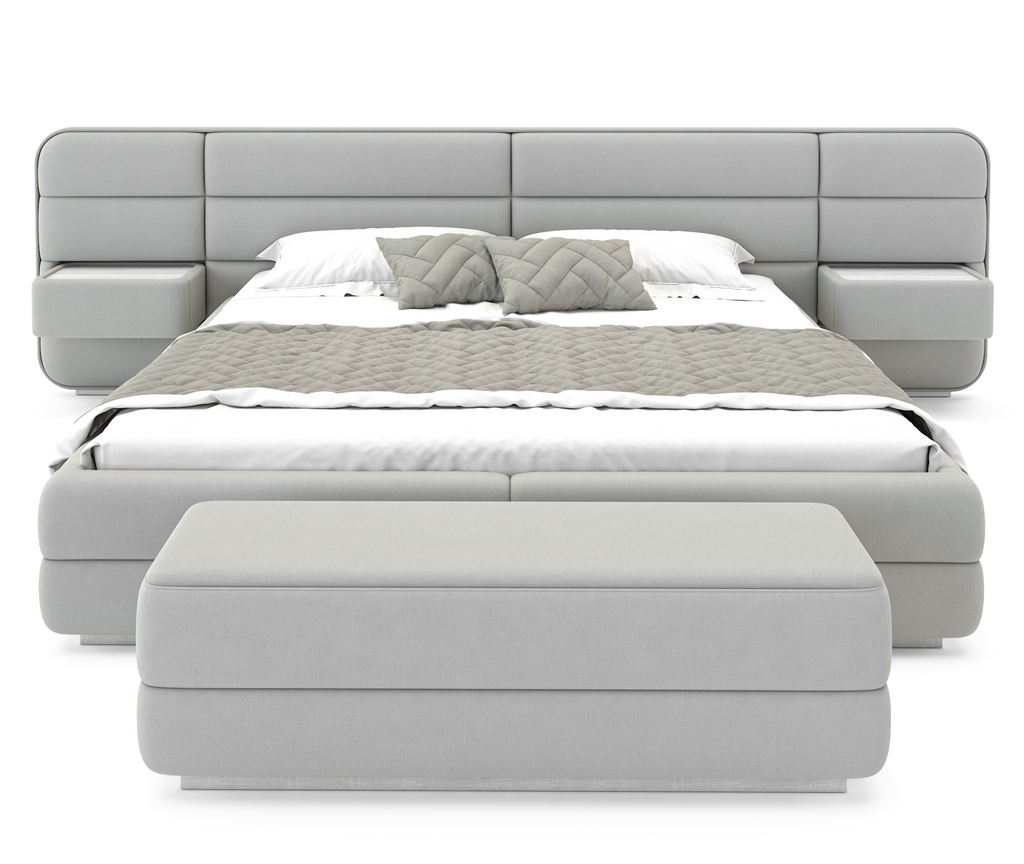 Velastra Bed with gray upholstered frame, integrated nightstands, white mattress, and ottoman